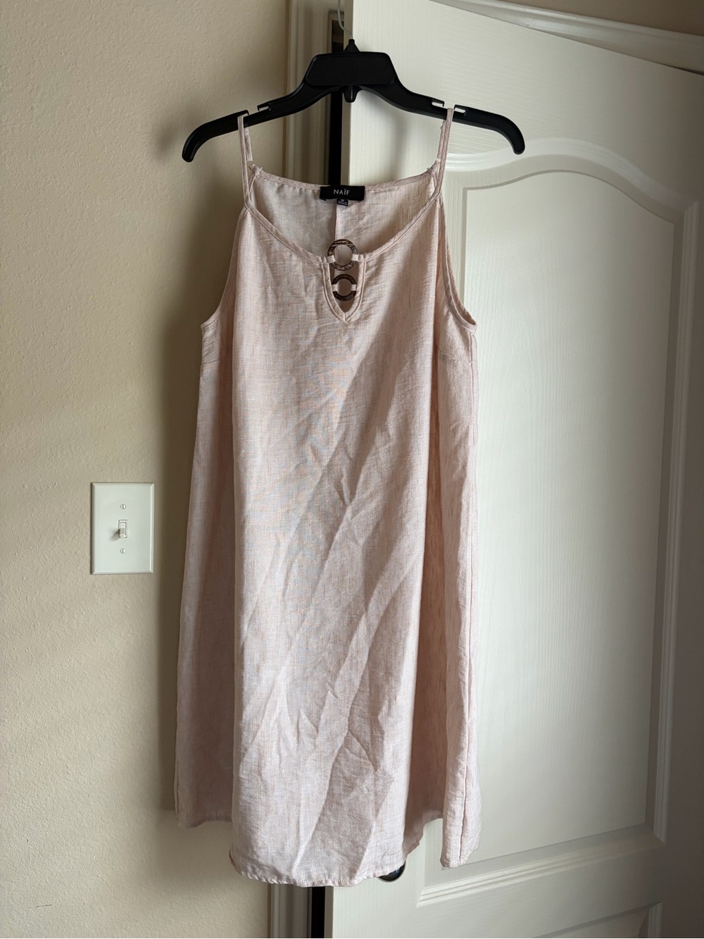 NAIF cream midi dress with gold buckle design and adjustable strap.